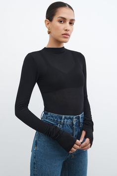 Get back to the basics with our Liana Mock Turtleneck. Our fresh, transitional essential with a sleek fit is oh-so-versatile, perfect for day-to-night wear. She's crafted from our beloved high-stretch, sheer European jersey and features extra-long sleeves with thumbholes for even more snugness.[SPLIT] Natalee, in light beige, is 5'10" (178 cm) tall, wearing size M. Astrid, in black, is 5'9" (175 cm) tall, wearing size XS. Martyna, in anthracite, is 5'10" (178 cm) tall, wearing size XS. Total len Basic Turtleneck, 2024 Lookbook, Unique Tops, Turtleneck Outfit, Extra Long Sleeves, Blue Label, Sweatshirt Fabric, Turtleneck Top, Night Wear