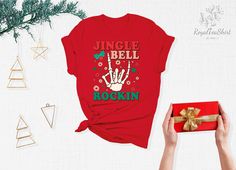 "Jingle Bell Rockin Shirt, Jingle Bell Shirt, Christmas Song, Christmas Vacation Shirt, Christmas Shirt, Christmas Shirts, Christmas Gifts Link for Backside Printing https://www.etsy.com/listing/1091793828/backside-upgrade?ref=shop_home_active_1&frs=1 - How To Order - Please, check and review all photos Choose your t-shirt color and size Click add to cart. You can go back to add more product Click \"Proceed to check out\" -PRODUCT- We use high quality soft style shirt brands. Solid colors: 100% Preshrunk Cotton, Heather Colors: 52% Cotton - 48% Poly We make black design for White, Pink, Athletic Heather, Orange and Heather Peach White design is used by other colored shirts. -CARE INSTRUCTIONS- Wash item inside out in cold water Do not bleach Do not dry clean Do not iron directly on the des Red Holiday Shirt For Gift, Red Holiday Shirt Gift, Holiday Red Shirt As Gift, Christmas Vacation Shirt, Christmas Vacation Shirts, Jingle Bell, Holiday Memories, Christmas Vacation, Christmas Song