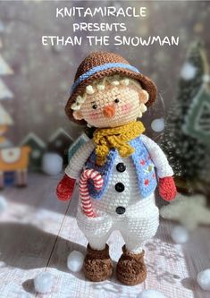 a knitted snowman with a hat and scarf