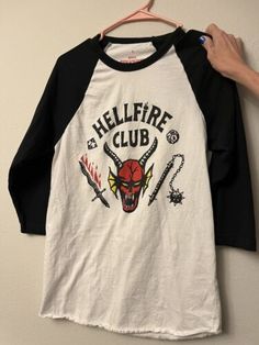 Stranger Things Netflix Hellfire Club Unisex Small Adult Baseball Tshirt | eBay Halloween Streetwear Tops With Logo Print, Halloween Logo Print Tops For Streetwear, Hip Hop Crew Neck Top With Front Print, Hip Hop Cotton Tops With Back Print, Halloween Crew Neck T-shirt With Logo Print, Halloween Crew Neck Tops With Logo Print, Casual Halloween T-shirt With Logo Print, Halloween Logo Print Crew Neck T-shirt, Grunge Crew Neck Tops For Fan Merchandise