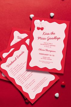 two red and white wedding cards with cherries on the bottom one is for kiss the miss goodbye