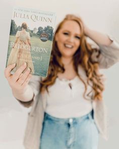 a woman holding up a book in front of her face