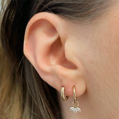 Put some complementary color in your lobes with these Charming Huggie Hoop Earrings with Petal Pendant. Featuring a petal pendant in a simple, classic design, these earrings are perfect for adding a bit of stylish flair to any look. So hug your ears with these cuties and get ready to turn heads!