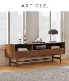 a living room scene with focus on the coffee table and bookshelf in the foreground