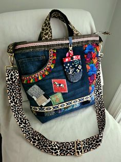 an animal print purse sitting on top of a white chair