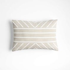 a beige and white striped pillow on a white wall