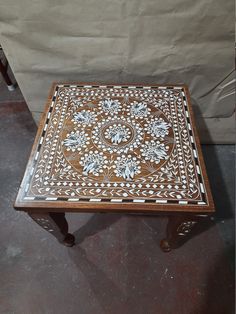 a wooden table with white and brown designs on it