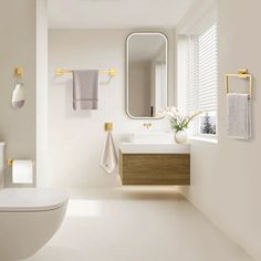 a bathroom with white walls and flooring next to a sink, toilet and mirror