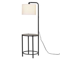 a lamp that is next to a table with a light on it and a floor lamp