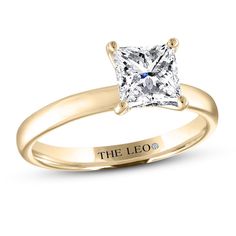 a yellow gold engagement ring with a princess cut diamond in the center, on a white background