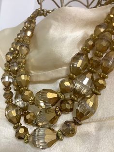 "A stunning sparkly glass bead necklace circa 1940s with beautiful lovely quality faceted beads. The longest base strand measures 16 1/2\" end to end  The necklace drops down 8 1/2\" from top to base, bear in mind please that this measurement changes when around the neck so it sits like a choker." Vintage Gold Beads For Party, Vintage Gold Beaded Necklace With Faceted Beads, Vintage Gold Beaded Necklaces With Faceted Beads, Sparkly Costume, Golden Mirror, Three Strand Necklace, Christmas Necklace, Enamel Flower, Glass Bead Necklace