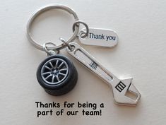 a keychain with a car tire and thank you written on it that says, thanks for being a part of our team