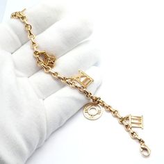 About This Piece: This vintage Tiffany & Co. Atlas charm bracelet from 2003 is finely crafted in 18k yellow gold. It features the iconic Atlas design in 5 charms, embodying timeless elegance and sophistication. The bracelet's delicate yet bold aesthetic showcases Tiffany's exquisite craftsmanship, making it a coveted piece for collectors and enthusiasts of luxury jewelry. Metal: 18k yellow gold Length: 7" Weight: 29.7 grams Details: 5x Atlas Charms XII has hallmark "Atlas 2003" Hallmarks: T&Co 7 Luxury Charm Bracelet With Logo Charm As Gift, Luxury Logo Charm Bracelet As Gift, Luxury Gold-tone Tarnish Resistant Charm Bracelet, Elegant Charm Bracelet With Logo Charm As Gift, Elegant 14k Gold Charm Bracelet, Luxury Tarnish Resistant Charm Bracelet, Elegant Gold Jewelry With Logo Charm, Formal Yellow Gold Jewelry With Logo Charm, Classic Gold-tone Jubilee Charm Bracelet