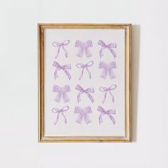 a framed painting with purple bows on it