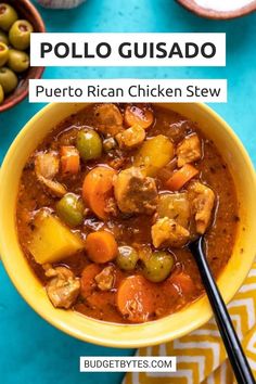 a yellow bowl filled with chicken stew and olives