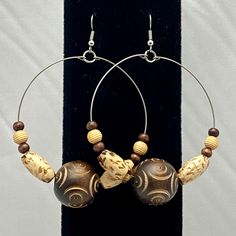 These stainless steel hoop earrings are made with 20mm brown decorative etched wooden beads, tan oval wooden beads and round beads. They are approximately 2 1/4 inch in diameter and 3 1/4 inches long and they have a surgical steel hook. Clear rubber earring backings included. Fredericksburg Va, Jewelry Earrings Hoops, Wooden Beads, Round Beads, Etching, Jewelry Inspiration, 4 Inch, Etsy Earrings, Jewelry Earrings