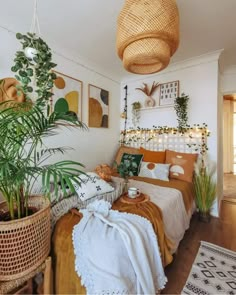 a bedroom with plants and pictures on the wall