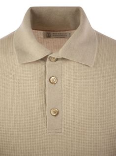 The quality of Brunello Cucinelli's materials renews the casual and versatile taste of the cashmere knit polo shirt with long sleeves. The natural yarn is worked to obtain the characteristic Waffle stitch texture that makes the surface of the garment dynamic. The fit offers regular and comfortable volumes. The noble cashmere fibre is characterised by its extreme fineness and valuable thermo-insulating qualities that guarantee at the same time warmth, protection and lightness when worn. - Rib kni Luxury Collared Polo Sweater, Casual Cashmere Tops With Buttons, Collared Cashmere Polo Sweater, Classic Cashmere Tops With Button Closure, Collared Cashmere Polo Shirt For Fall, Fall Cashmere Polo Shirt, Fall Cashmere Collared Polo Shirt, Classic Wool Collared Polo Sweater, Classic Beige Long Sleeve Polo Sweater