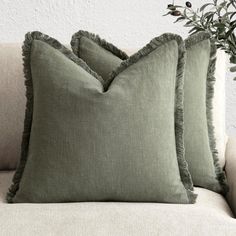 two green pillows sitting on top of a couch