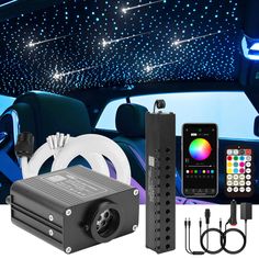 the interior of a car with blue lights and remote controls in front of it, along with other accessories