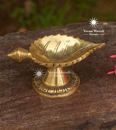 a gold colored decorative object sitting on top of a wooden table