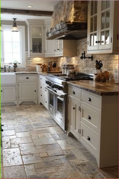 a large kitchen with white cabinets and marble counter tops on the floor is pictured in this image