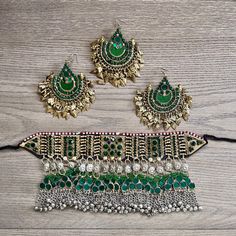 Beautiful handmade vintage Kuchi choker set would be the perfect set for your special event!  This set will make a statement and stand out with its beautiful uniform green glass stones and charming bells.  The Kuchi people are nomads and travel around different parts of Asia leaving behind beautiful pieces behind like this one.  This set is believed to be from the early 2000's and the entire piece is in immaculate condition aside from some oxidization or patina. This unique Kuchi set is outstand Green Metal Jewelry Sets For Wedding, Green Metal Jewelry For Festivals, Green Metal Choker For Party, Green Festive Jewelry Set For Ceremonial Occasions, Green Ceremonial Jewelry Set For Festive Occasions, Festive Green Jewelry Set For Ceremonial Occasions, Festive Green Ceremonial Jewelry Set, Vintage Green Necklace For Festivals, Bohemian Green Wedding Jewelry