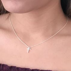 This tiny silver cross necklace is a classic addition to your layering necklaces. This minimalist necklace is also perfect by itself. The cross charm is sterling silver and measures approximately 12 mm in length or 1/2 inch. The chain is delicate looking but sturdy sterling silver. This dainty cross necklace is available in lengths from 15 - 18 inches. You may choose to add an attached extender. Your new necklace will come in a box, ready for gift giving. More Christian jewelry https://www.etsy. Minimalist Crucifix Jewelry With Delicate Chain, Dainty Cross Necklace For Everyday Wear, Simple Clavicle Chain Cross Jewelry, Sterling Silver Cross Necklace With Clavicle Chain, Simple Cross Clavicle Chain Jewelry, Delicate Everyday Cross Necklace, Simple Everyday Cross Jewelry, Minimalist Hypoallergenic Cross Jewelry, Everyday Cross Pendant Charm Necklace