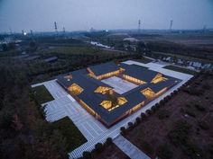 an aerial view of a building lit up at night