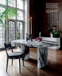 a marble dining table surrounded by two chairs