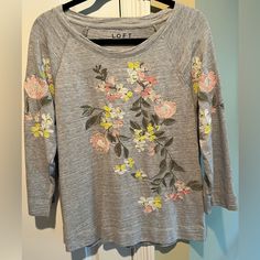 Loft Pretty Gray Sweatshirt With Embroidered Flowers On Front & Sleeves, Size Large. Tags Removed But Never Worn. 100 Percent Organic Cotton & Embroidered Flowers Are 100 Percent Polyester. Casual Embroidered Long Sleeve Tops, Spring Crew Neck Tops With Floral Embroidery, Casual Long Sleeve T-shirt With Floral Embroidery, Fall Cotton Tops With Floral Embroidery, Floral Embroidered Cotton Tops For Fall, Casual Crew Neck Tops With Embroidery, Casual Long Sleeve T-shirt With Multicolor Embroidery, Spring Long Sleeve T-shirt With Embroidered Graphics, Spring Embroidered Relaxed Fit Tops