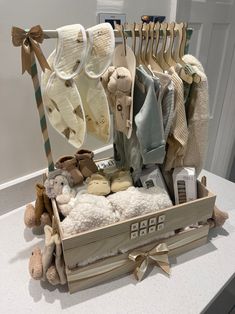 a wooden box filled with baby items on top of a white counter next to a mirror