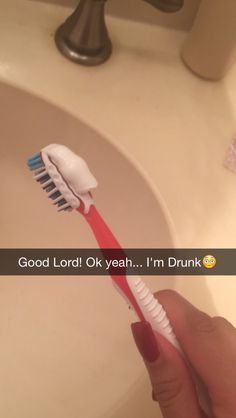 a person holding a toothbrush in front of a sink with the words good lord ok yeah i'm drunk