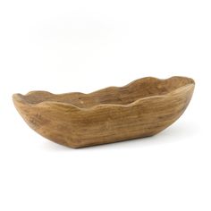 a wooden bowl sitting on top of a white surface