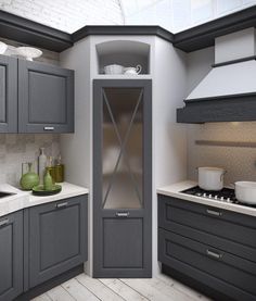 a kitchen with gray cabinets and white counter tops, along with an open glass door