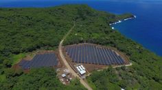 an aerial view of a solar farm near the ocean