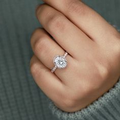 a woman's hand with a diamond ring on it