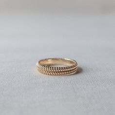 This is where it all started. A 4mm width ring made to be worn on its own or stacked with some friends. Each design is simply intricate, yet intricately simple. A modern day classic. Available in solid yellow or rose gold and sterling silver high polished or antiqued, sizes 5-9. All gold items are made to order and take approximately 10 business days to deliver, plus shipping time. Minimalist 14k Gold Ring With Decorative Band, Minimalist Yellow Gold Rings With Decorative Band, Minimalist Yellow Gold Ring With Decorative Band, Minimalist Promise Ring With Decorative Band, Dainty Stackable Couple Rings With Round Band, Minimalist 14k Gold Band With Decorative Details, Rose Gold Stackable Rings In Recycled Gold, Rose Gold Stackable Rings With Recycled Material, Rose Gold Recycled Gold Stackable Rings