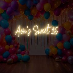 the neon sign says aha's sweet 16 surrounded by balloons