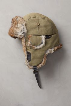 Winter waits at a distance when you're wearing this rugged trapper hat. Our canvas trapper offers the warmth and versatile good looks that take you through winter in comfort. The tightly woven cotton canvas with quilted cotton lining resists wind and cold. And the ultra-soft rabbit fur trim looks great and feels incredible, whether you wear the ear flaps down or tied up with the leather chin strap. Military Style Short Brim Winter Hat, Adjustable Winter Adventure Hat, Winter Hunting Cap, Outdoor Fleece-lined Hat With Ear Flaps, Fleece-lined Hat With Ear Flaps For Outdoor Activities, Military Hats For Winter Outdoor Activities, Outdoor Beanie With Faux Fur Lining, Fleece-lined Ear Flaps Hat For Outdoor, Winter Military Hat For Outdoor Activities