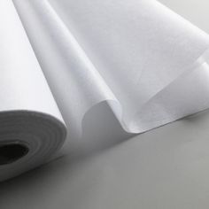 three rolls of white fabric on top of each other