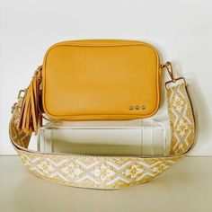 This Faux-leather crossbody bag is so soft and dreamy. Comes with a trendy and fun canvas strap and shiny gold classic hardware! Zippered Top and linen beige interior with a zippered stash pocket on the inside.  Adjustable shoulder strap up to 46 inches. Bag measures 9.5" x 6" x 2" Main material: PU pebble Leather; Other: poly-cotton liner Spot clean Guitar Strap Bag, Beige Interior, Everyday Purse, Guitar Strap, Zipper Top, Everyday Bag, Bag Straps, Kate Spade Crossbody, Pebbled Leather