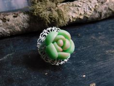 a green ring sitting on top of a wooden table