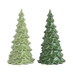 two green ceramic christmas trees sitting next to each other