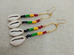 The earrings are 4 inches long. The earrings are beaded with glass beads and cowrie shells. The earrings are handmade and light weight. It is on a stainless steel gold wire and will come with back stoppers. If you have any questions please feel free to contact us at anytime. Beach Heishi Beaded Earrings, Adjustable Heishi Beads Earrings For Beach, Handmade Beaded Earrings With Round Beads For Vacation, Adjustable Beaded Earrings With Dangling Beads For Beach, Heishi Beads Beaded Earrings For Beach, Beach Beaded Heishi Earrings, Beaded Heishi Beads Earrings For Beach, Bohemian Heishi Beads Earrings For Beach, Beach Wire Wrapped Beaded Drop Earrings