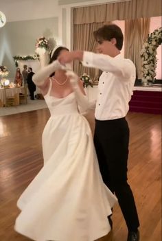 a bride and groom are dancing on the dance floor