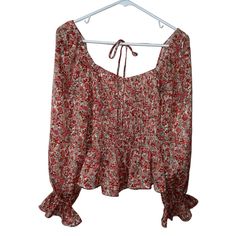 Add Some Bohemian Flair To Your Wardrobe With This Lucy Paris Blouse. The Multicolor Floral Pattern Adds A Pop Of Color To Any Outfit, While The Boat Neckline And Tie In The Back Give It A Unique And Feminine Touch. The Classic Fit And Long Sleeves Make It Perfect For Any Occasion, And It's Machine Washable For Easy Care. This Blouse Is Brand New With Tags And Made From 100% Polyester, Ensuring Quality And Durability. 100% Polyester Red Bohemian Fall Blouse, Red Floral Print Peasant Top, Red Peasant Top For Fall, Red Long Sleeve Blouse For Vacation, Red Long Sleeve Peasant Top With Floral Print, Red Floral Print Peasant Top For Fall, Spring Red Peasant Blouse, Long Sleeve Red Peasant Top With Floral Print, Red Peasant Blouse For Spring