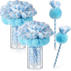 two vases filled with blue and white candy lollipops next to each other