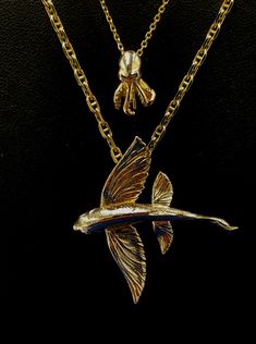 This Flying Fish “In Flight” is a remarkable piece of art, crafted from precious or semi precious alloys upon request including 10K, 14k, 18 K white and yellow gold as well as , .925 Sterling Silver and 935 Argentium (non-tarnish) silver, and set with precious gemstone eye. Like all fish pendants by Nautical Treasure Jewelry, this Flying Fish pendant includes a free leather necklace in the size of your choice. Leather necklaces are available in the sizes 18'', 20", 22", and 24". This pendant is Fish Pendant Gold, Octopus Pendant, Treasure Jewelry, Flying Fish, Fish Necklace, Fish Pendant, Tarnished Silver, Nautical Jewelry, Silver Eagles