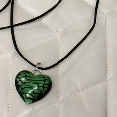 "The Green & Black Heart Necklace 🤍 Featuring a large murano glass heart pendant and a 48\" cut suede string cord. There are a ton of ways to wear this necklace (you can even wear it as a waist belt!) and if you need a custom length, DM me!  Handmade glass heart pendants~ no two are the same! Unisex 🖤 Made with love 🫶" Chunky Heart Necklace, Chunky Pendant Necklace, Black Heart Necklace, Big Heart Necklace, Big Pendant Necklace, Cute Anklets, String Necklace, Heart Choker Necklace, Pretty Jewelry Necklaces